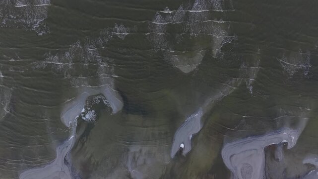Aerial top down view of waves crashing on shore of Great Salt Lake, Utah