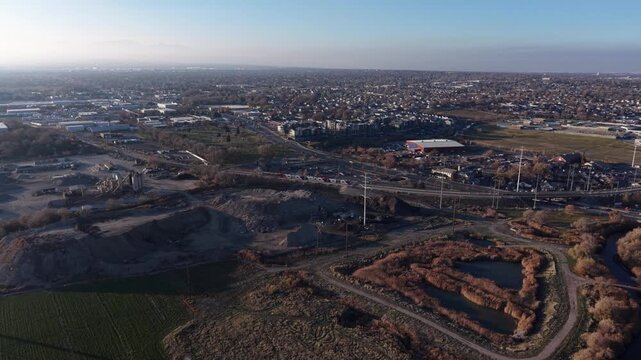 Aerial view of train, gravel pit, and wetlands in Midvale, Utah, USA