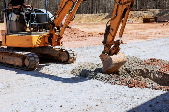 Heavy machinery digs hole at construction site