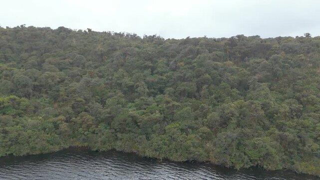 Aerial perspective of Buey Lagoon in Purace National Park, revealing a serene landscape of dense vegetation and misty mountains