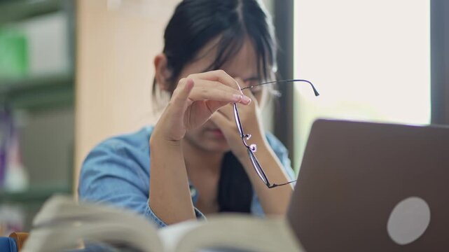 Young woman studying in a library focused on her work indoor setting close-up view for academic success