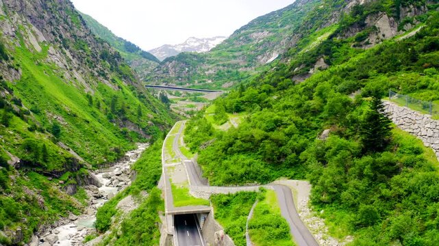 Switzerland. Picturesque winding mountain road with tunnels Gotthardstrasse. Drone footage