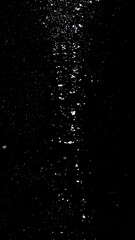 Obraz premium A black background with a vertical streak of white specks