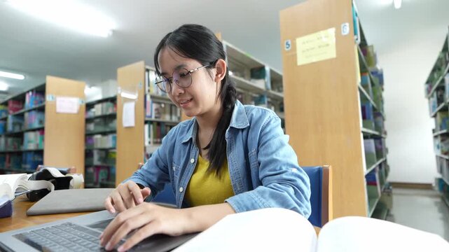 Student engaged in research library educational activity indoor setting close-up focus learning process