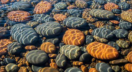 Obraz premium Vibrant colorful rocks on shoreline beach.