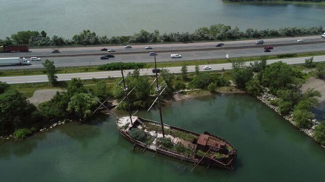 La Grande Hermine, the Jordan Harbour Shipwreck vessel visible along the QEW in Ontario, Canada, on Lake Ontario. Aerial shot with the QEW in the background. .