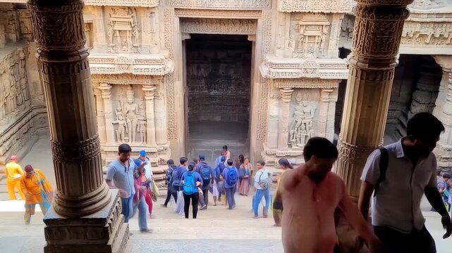 Exploration of intricate ancient temple with visiting tourists in India