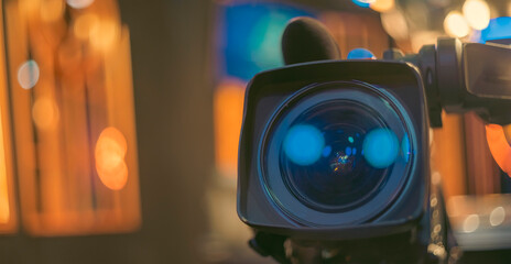 Professional Cinema Camera Lens with Blue Flare and Bokeh Background with Copy Space