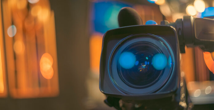 Professional Cinema Camera Lens with Blue Flare and Bokeh Background with Copy Space