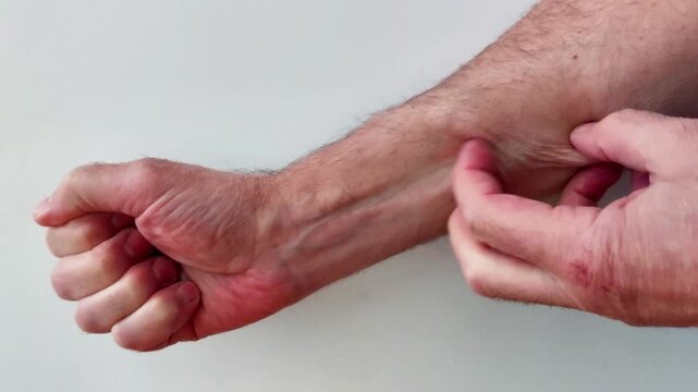 Finger scratching forearm to demonstrate skin contact, texture, and everyday body interaction, useful for anatomy detail, tactile action, or lifestyle demonstration footage