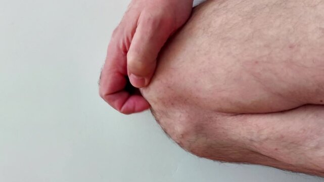 Fingers scratching knee to highlight everyday body contact, tactile action, and natural movement, useful for anatomy detail, lifestyle scenes, or gesture demonstration footage