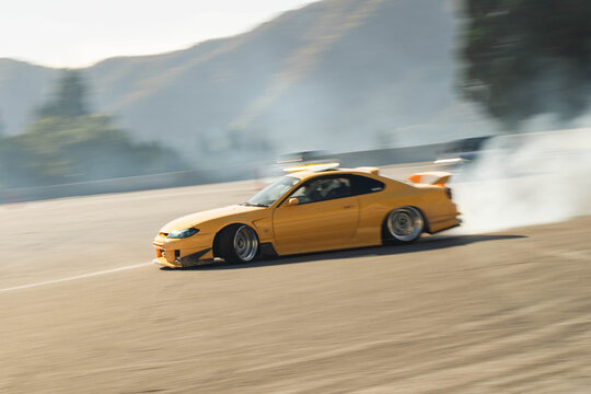 Yellow car drifting on a race track
