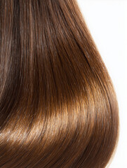 Fototapeta premium A macro close-up of long, straight brown hair with a glossy, healthy shine against a white background.