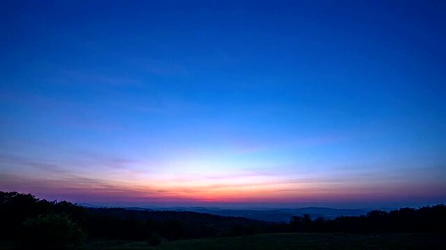 Twilight Horizon: A mesmerizing panorama of the twilight sky painted with vibrant hues, the sun's final light kisses the distant landscape, with an evocative sense of peace and wonder.