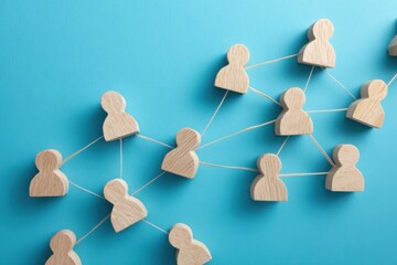 Fototapeta premium Networked Connections: Conceptual image showcasing connected wooden figures on a backdrop, illustrating the concept of relationships, communication, and interconnectedness. 