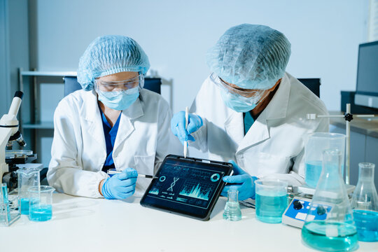 Medical scientists performing biotechnology laboratory research with DNA molecular analysis, microscope testing and digital healthcare technology