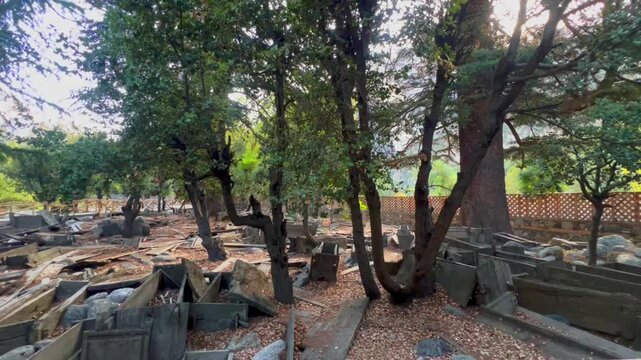 Cinematic 4k video of ancient Kalash Wooden Coffins in an Open Air Graveyard, Bumburet Valley, Chitral, Pakistan, Panning from top right to bottm left