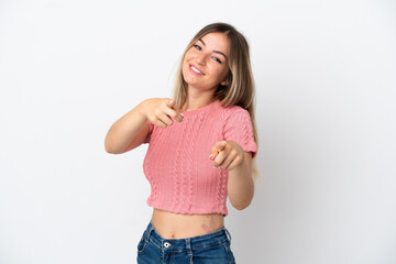 Young Romanian woman isolated on white background surprised and pointing front
