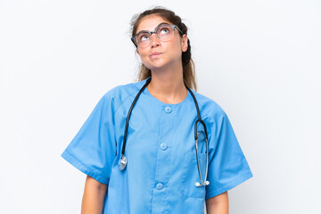 Fototapeta premium Young nurse doctor woman isolated on white background and looking up