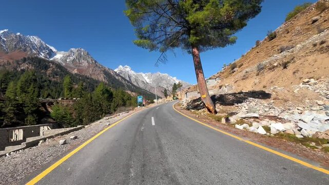 Cinematic 4k horizontal footage of Driving on Scenic Mountain Highway toward Snow-Capped Peaks - Naltar Highway - POV Forward Motion - Northern Pakistan Road Trip