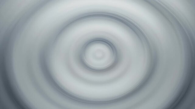 Soft radial blur abstract featuring gentle, concentric rings in shades of gray and white
