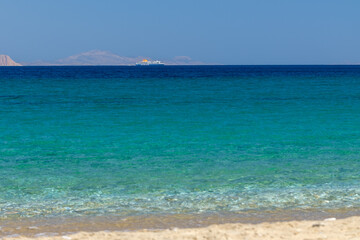 Fototapeta premium View of the crystal clear waters of the turquoise dream beach of Agia Theodoti in Ios Greece