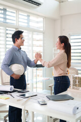 Asian architects engineers construction professionals handshake agreement office meeting project...