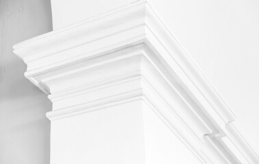 Detailed image of an intricately designed white cornice, abstract white architectural background photo © evannovostro