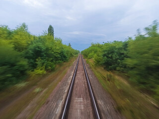 Obraz premium View from the train window on the rails going into the distance