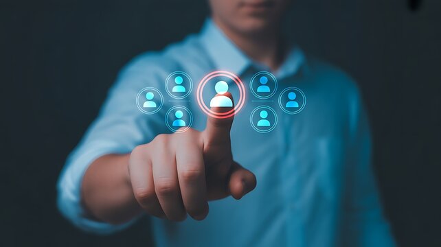 Man's hand selecting a person from a group of people displayed on a digital screen, emphasizing human resources and selection