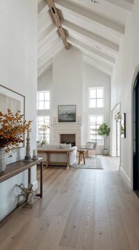 Large foyer in a modern home tour, featuring clean architectural lines and layered neutral tones that create a sense of understated luxury.