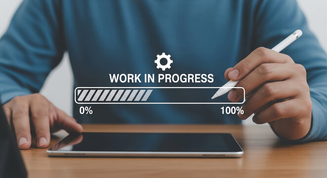 A person working on a tablet with a work in progress bar