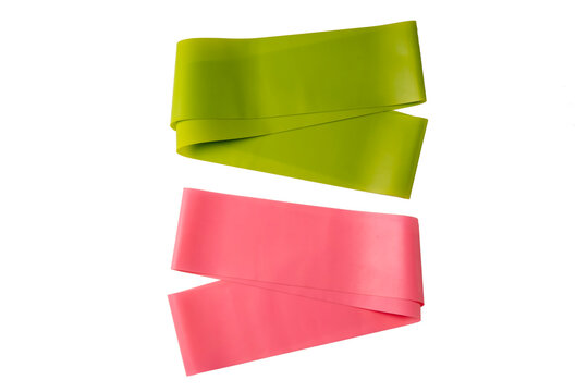Set of elastic bands for fitness isolated on white. Pink and green fitness bands of different resistance levels.