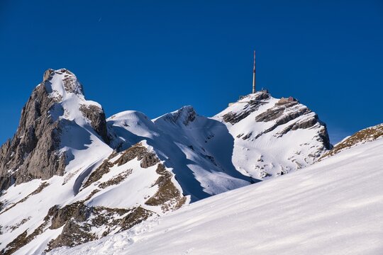 S&auml;ntis in the Appenzell Alps. Ski tour in the Alpstein region. Photo from Rotsteinpass. Ski tour in rugged terrain. Skier enjoys the view of the snow-covered mountains. High quality photo
