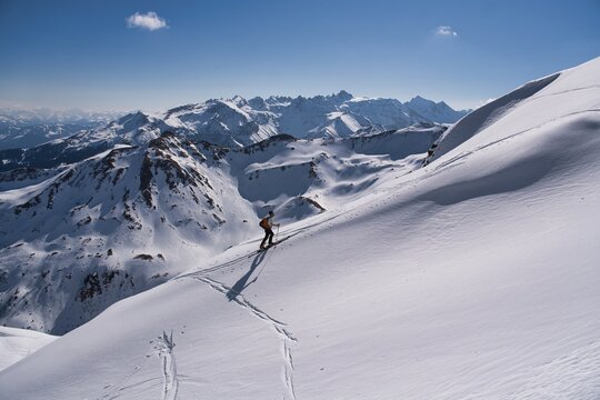  A ski tourer ascends the beautiful Swiss mountains. Ski mountaineering in winter. Climbing Mount Hochfinsler. High quality photo