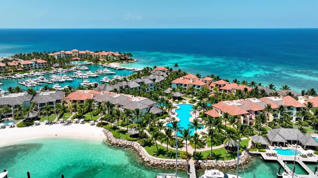 Aerial view of a luxurious tropical resort with turquoise water and yachts in punta cana