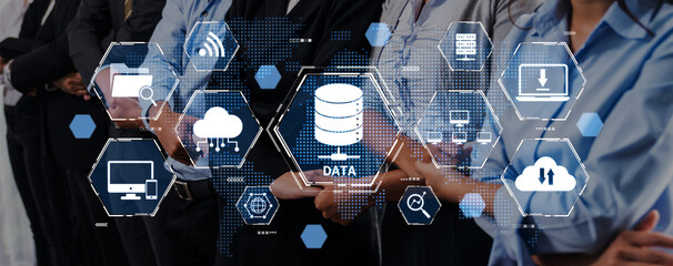 A diverse business team stands together with a backdrop of data visualization icons, symbolizing teamwork in the age of digital transformation and technology. Trope © InfiniteFlow