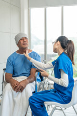 Obraz premium A male cancer patient in a wheelchair receives IV therapy while a female doctor offers care encouragement and updates on his test results providing support and discussing health progress