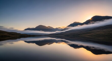 Fototapeta premium Misty Scottish Highlands Mountains Reflected in Calm Lake at Sunrise