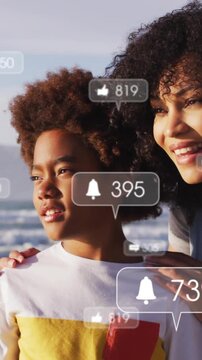 Vertical video: Mom holding son at beach as bells appearing around, likes changing for social media