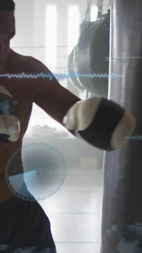 Vertical video: Boxer shifting weight throwing punches at heavy bag with HUD tracking for training