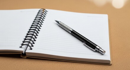 Naklejka premium A sleek silver and black pen rests on an open spiral-bound notebook with blank lined pages