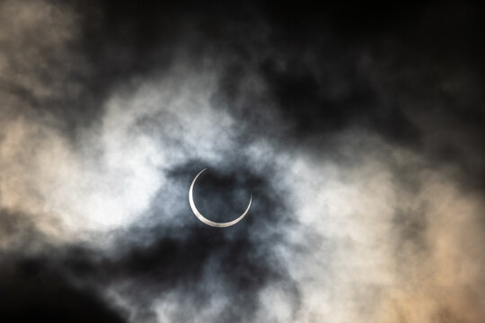 Partial phase of the annular solar eclipse covered in clouds photographed in San Antonio, Texas USA	