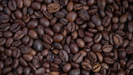 Coffee beans closeup, Vivid roasted coffee bean imagery, Detailed shot of glossy roasted beans, Intimate perspective emphasizing warm tones and fresh aroma of roasted coffee beans