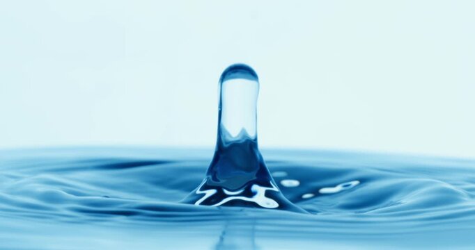 Drop of water falls into a drop of water in a super slow motion. Shot on super slow motion 1600 fps.
