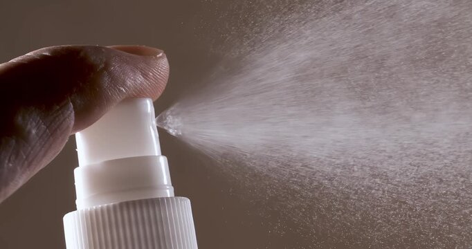 Liquid spraying fountain in a super slow motion of vaporized liquids particles. Shot on super slow motion camera 1600 fps. Spraying perfume.