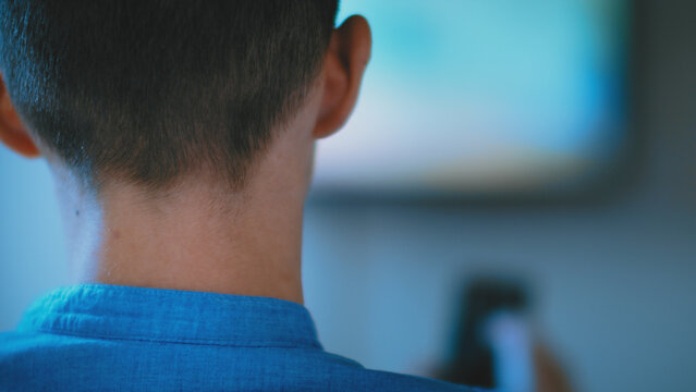 Man Watching TV and Changing Channels, Rear View, have fun and enjoy