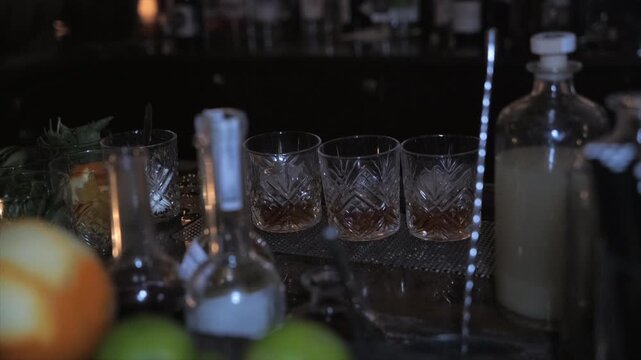 Close-up of rum and whisky glasses behind bar