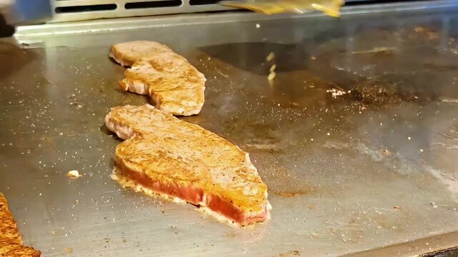 Chef basting beef steak with butter, Sirloin Cut, Teppanyaki Grilled Meat Dish, Japanese Barbecue Lunch Dinner Cuisine, Medium Shot