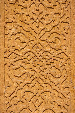 Closeup view of mughal era islamic geometric pattern carving on golden sandstone, Isa Tarkhan II mausoleum, Makli necropolis, Thatta, Sindh, Pakistan